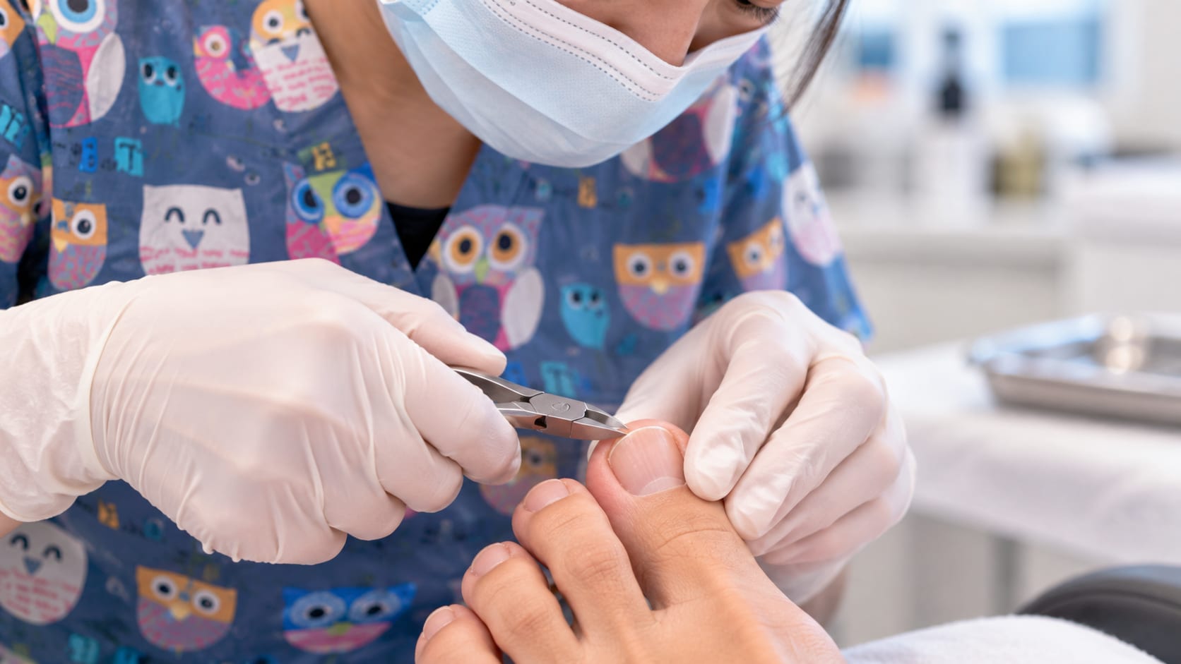 Close-up of a podiatrist trimming the edge of a big toenail with specialised nail clippers