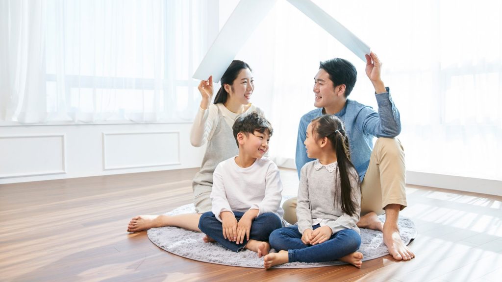 Happy family spending time together at home, encouraging a healthy lifestyle to support child posture correction.