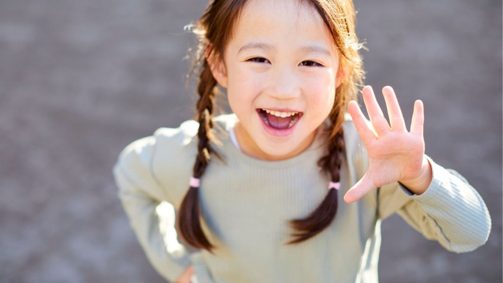 Happy young girl showing confidence after scoliosis in children treatment