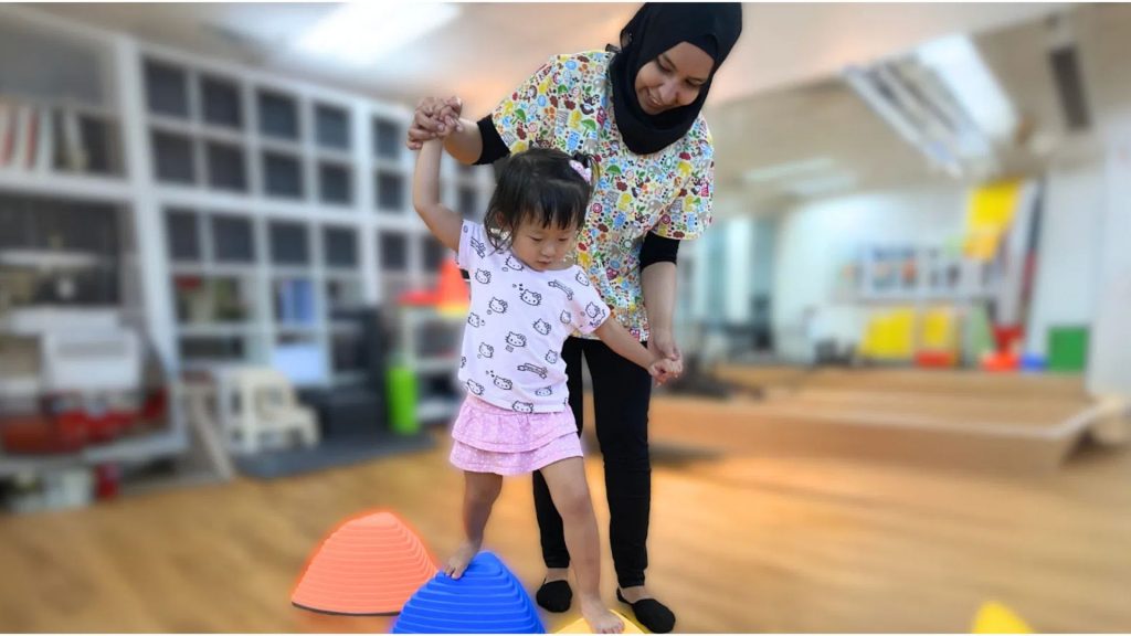 Child doing balance therapy with physiotherapist for scoliosis in children