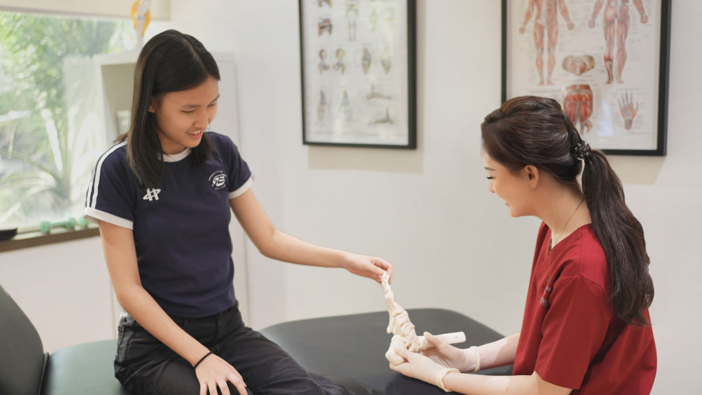 Podiatrist guiding a young patient through targeted foot therapy to treat heel pain in children caused by Sever’s disease.